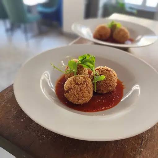 Croquettes dorées et croustillantes sur fond de sauce tomate relevée